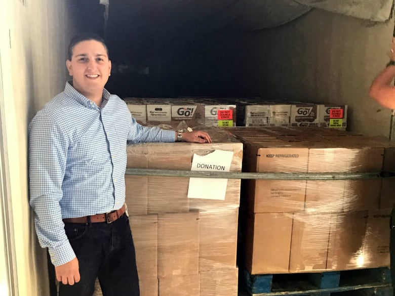 Jon Gianini from the shipping company HarbyrCo loads truck with donated dairy products for hurricane victims.